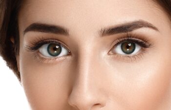 Eyes woman lashes. Beautiful Brunette Woman Portrait with healthy Hair.Clear Fresh Skin.Smiling Girl Isolated on a White Background.Skincare.Spa.Beauty Model